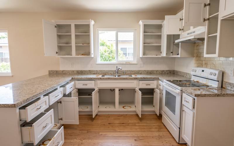 Illustration of the same empty kitchen with every cabinet open before cleaning